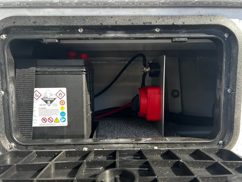 Slide: The Image of Battery compartment of 2024 Fish Rite Angler 18 boat with safety labels. - 11