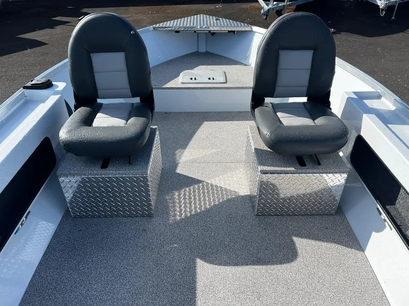Slide: The Image of 2024 Fish Rite Angler 18 boat interior with two cushioned seats and diamond plate storage. - 15