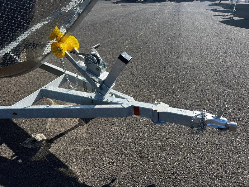 Slide: The Image of 2024 Fish Rite Angler 18 boat trailer hitch on asphalt. - 18