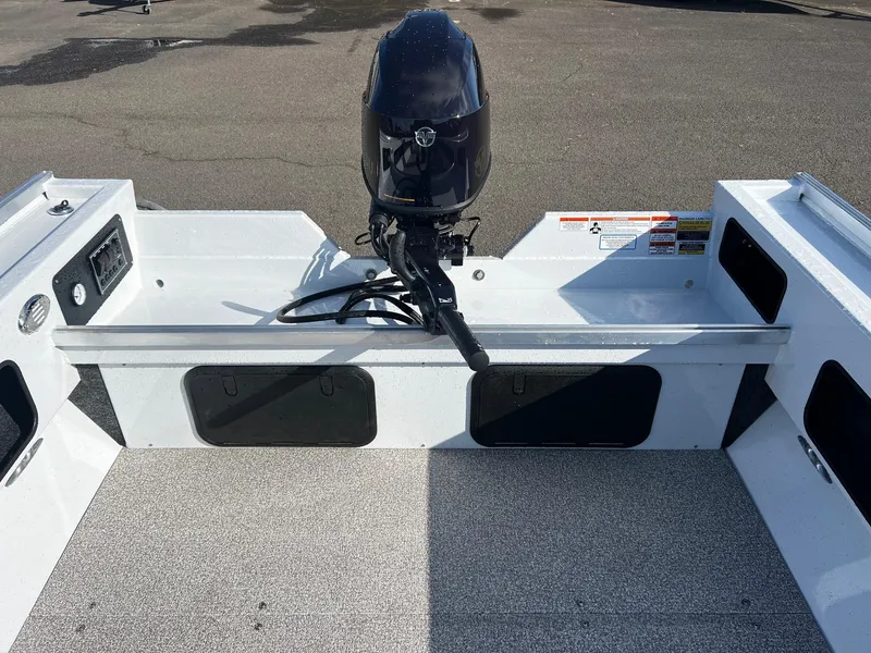 Slide: The Image of 2024 Fish Rite Angler 18 boat interior with motor. - 9