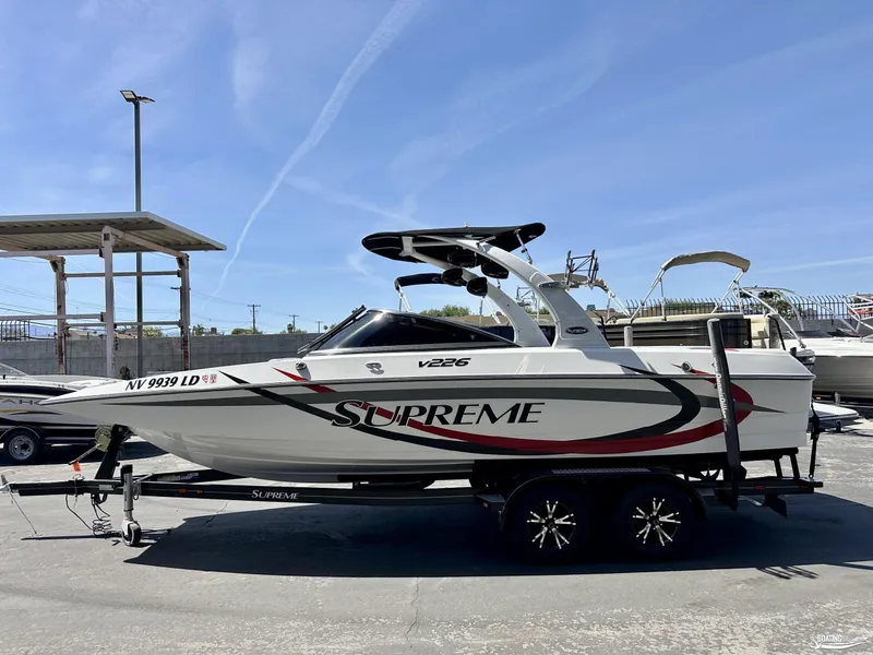 Slide: The Image of 2013 Supreme V226 boat on trailer in marina. - 0