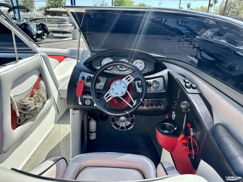 Slide: The Image of 2013 Supreme V226 boat dashboard with steering wheel, gauges, and controls. - 10