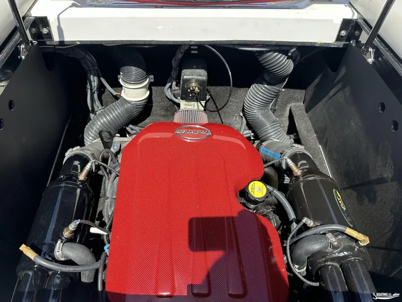 Slide: The Image of 2013 Supreme V226 boat engine with red cover and black components. - 11