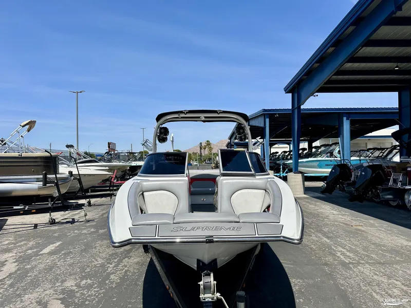 Slide: The Image of 2013 Supreme V226 boat at a marina, surrounded by other boats. - 6