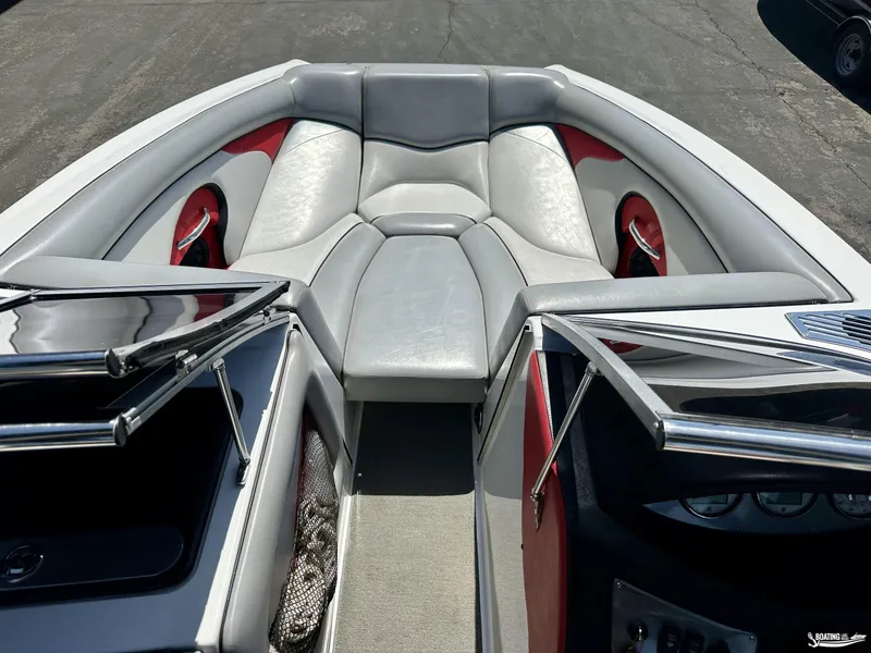 Slide: The Image of 2013 Supreme V226 boat interior with gray and red seating, open windshield. - 7