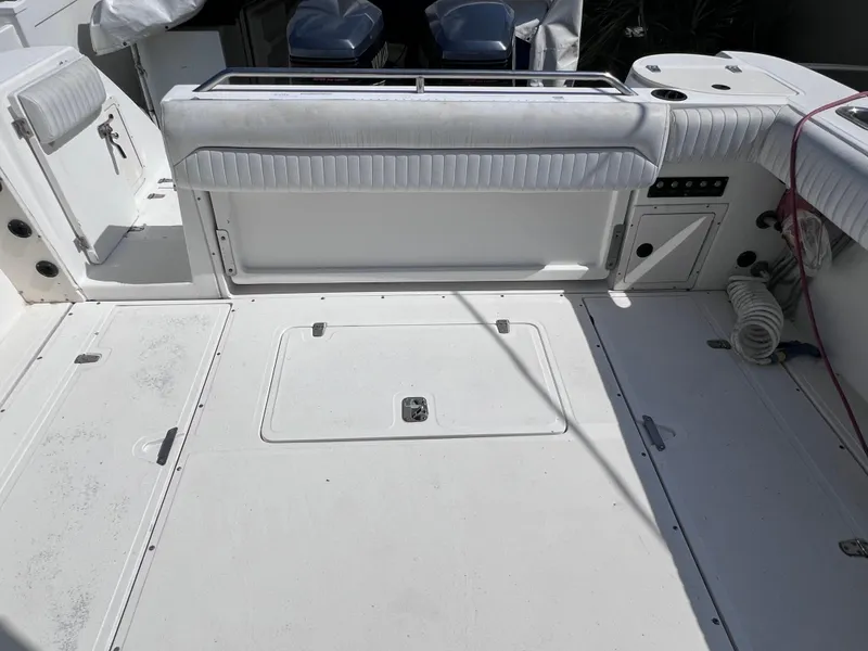 Slide: The Image of 2000 Boston Whaler 28 Conquest boat deck with storage compartments and seating. - 11