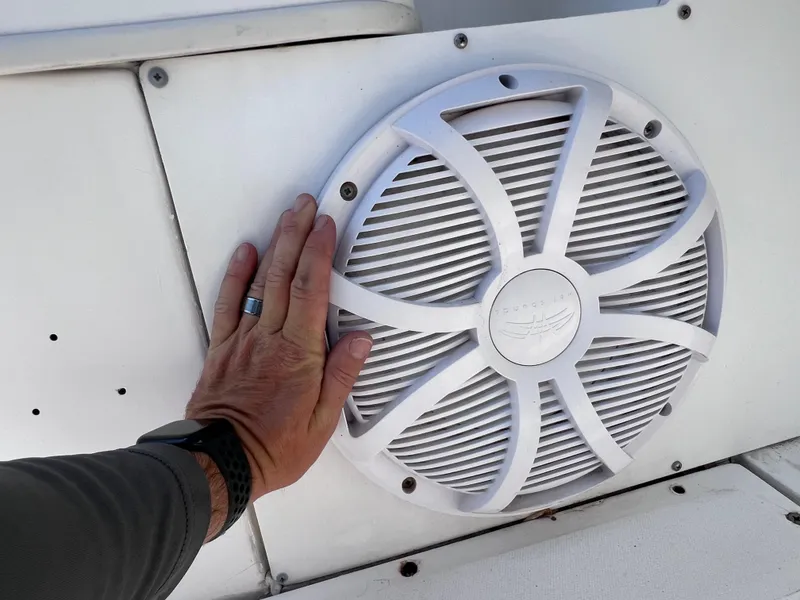Slide: The Image of Hand touching speaker on 2000 Boston Whaler 28 Conquest boat. - 16