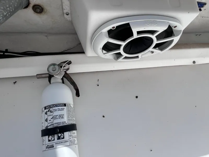 Slide: The Image of Fire extinguisher and speaker on a 2000 Boston Whaler 28 Conquest boat. - 17