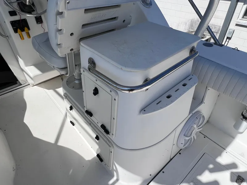 Slide: The Image of 2000 Boston Whaler 28 Conquest boat interior with seating and storage compartments. - 18