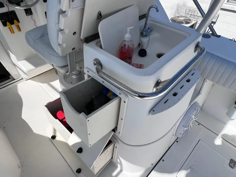 Slide: The Image of Boston Whaler 28 Conquest 2000 boat interior with sink and storage drawers. - 19