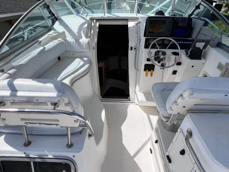 Slide: The Image of 2000 Boston Whaler 28 Conquest boat interior with helm and seating area. - 20
