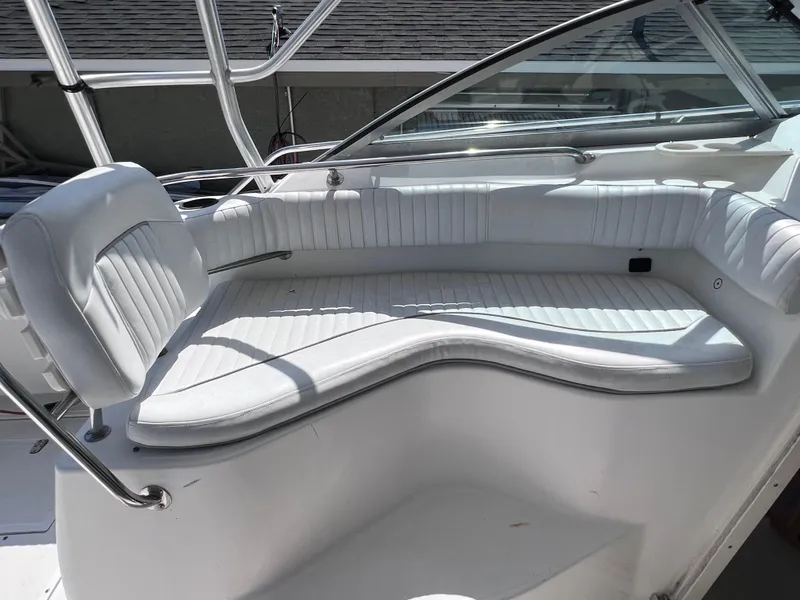 Slide: The Image of Boston Whaler 28 Conquest 2000 boat interior with white cushioned seating. - 21