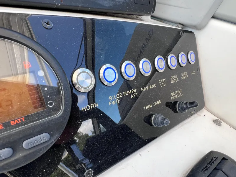 Slide: The Image of Control panel of a 2000 Boston Whaler 28 Conquest boat with various switches. - 27