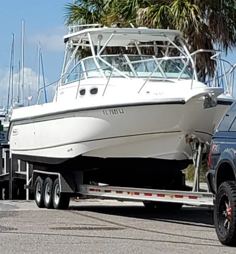 Slide: The Image of 2000 Boston Whaler 28 Conquest boat on a trailer, ready for transport. - 3