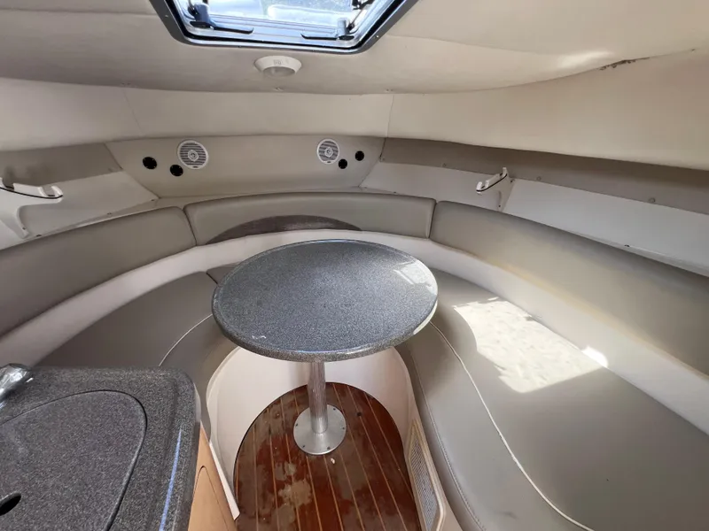 Slide: The Image of Interior cabin of a 2000 Boston Whaler 28 Conquest boat with seating and table. - 38