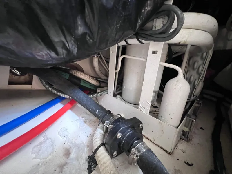 Slide: The Image of Engine compartment of a 2000 Boston Whaler 28 Conquest boat with hoses and components. - 40