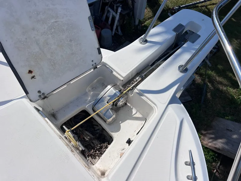 Slide: The Image of Anchor storage compartment on a 2000 Boston Whaler 28 Conquest boat. - 44