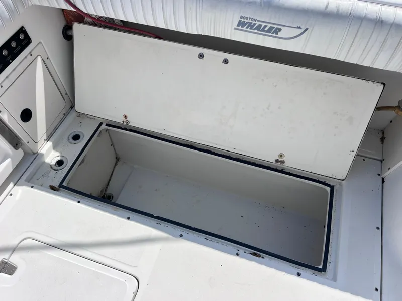 Slide: The Image of Open storage compartment on a 2000 Boston Whaler 28 Conquest boat. - 45