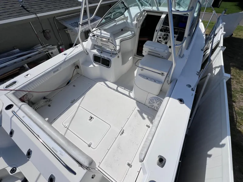 Slide: The Image of 2000 Boston Whaler 28 Conquest boat interior, featuring spacious deck and seating area. - 9