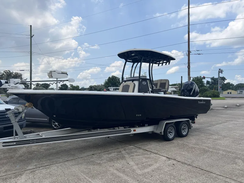 Slide: The Image of 2021 Tidewater 2500 Carolina Bay boat on trailer in parking lot. - 18