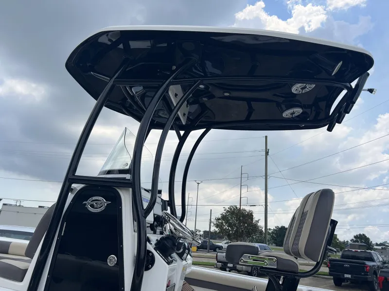 Slide: The Image of 2021 Tidewater 2500 Carolina Bay boat with T-top and seating, under cloudy sky. - 3