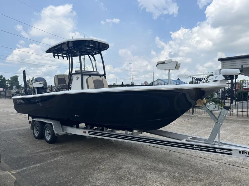 Slide: The Image of 2021 Tidewater 2500 Carolina Bay boat on trailer under blue sky. - 5
