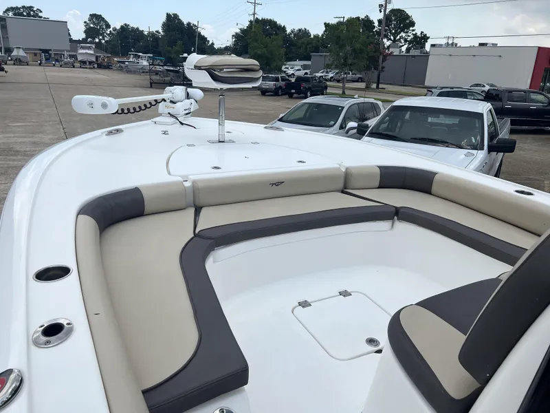 Slide: The Image of 2021 Tidewater 2500 Carolina Bay boat with cushioned seating and trolling motor. - 7