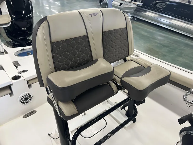 Slide: The Image of 2021 Tidewater 2500 Carolina Bay boat seats with cushioned backrests and armrests. - 9