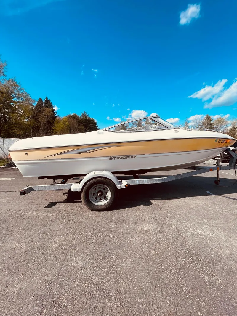 Slide: The Image of 2005 Stingray 195 LS/LX/LR boat on trailer under clear blue sky. - 2
