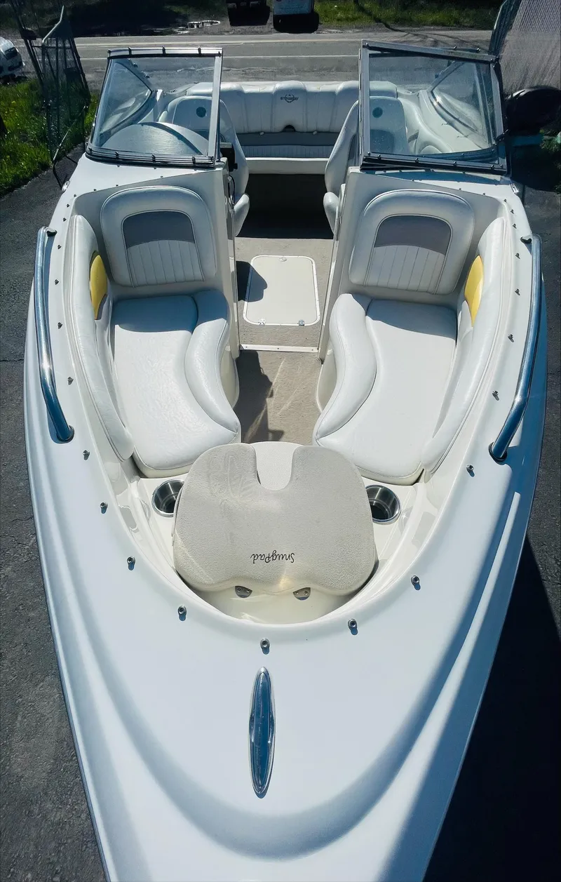 Slide: The Image of 2005 Stingray 195 LS/LX/LR boat interior with white seating and open bow design. - 5