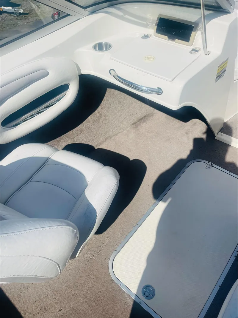 Slide: The Image of 2005 Stingray 195 LS/LX/LR boat interior with white seating and dashboard. - 7