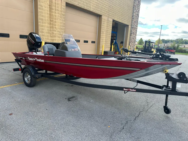 Slide: The Image of 2024 Tracker Bass Tracker Classic XL boat in red, parked on a trailer. - 3