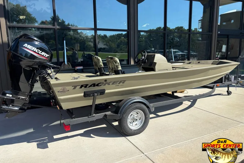 Slide: The Image of 2024 Tracker Grizzly 1754 SC boat with Mercury engine on trailer, outside D&R Sports Center. - 2