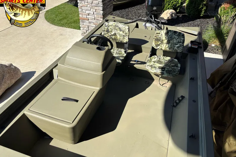 Slide: The Image of 2024 Tracker Grizzly 1754 SC boat interior with camouflage seats and steering console. - 5