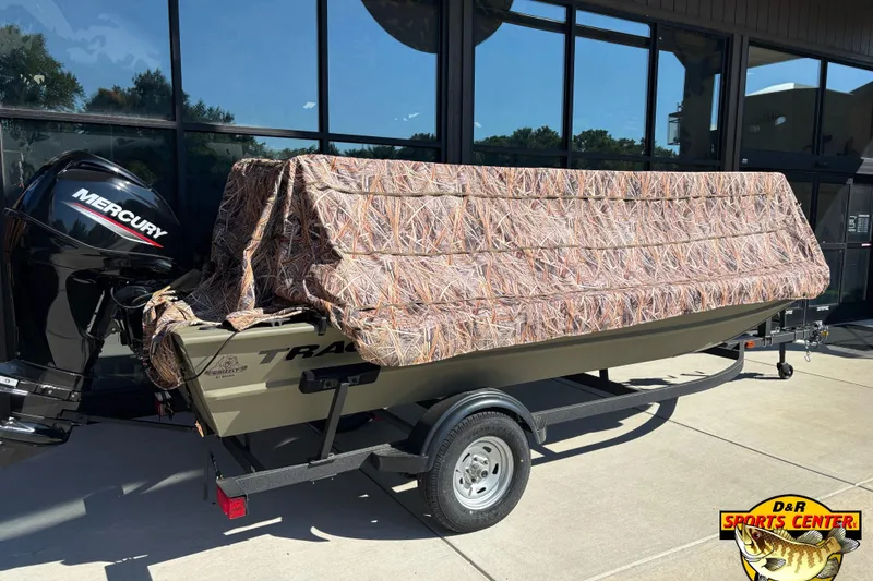 Slide: The Image of 2024 Tracker Grizzly 1754 SC boat with camouflage cover and Mercury outboard motor. - 7