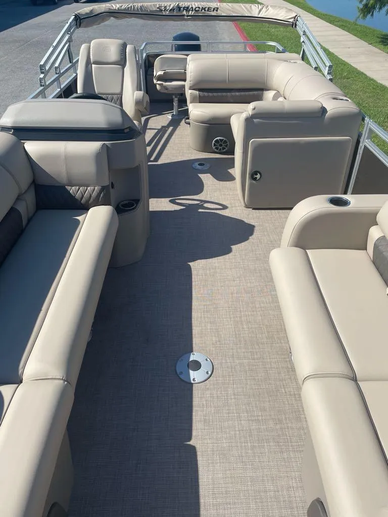 Slide: The Image of 2024 Sun Tracker SportFish 22 DLX pontoon boat with spacious seating and modern design. - 3