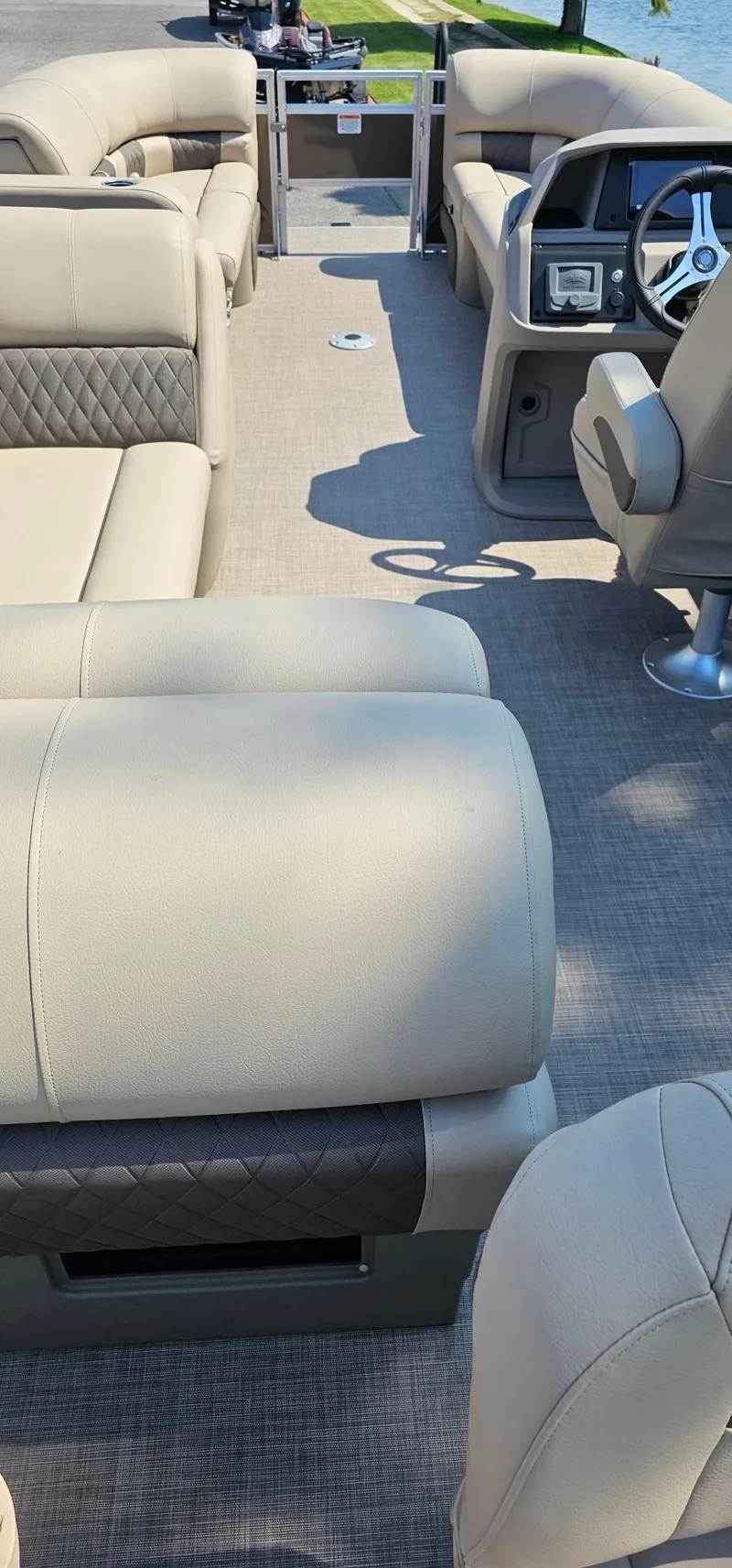 Slide: The Image of 2024 Sun Tracker SportFish 22 DLX interior with beige seating and steering console. - 4
