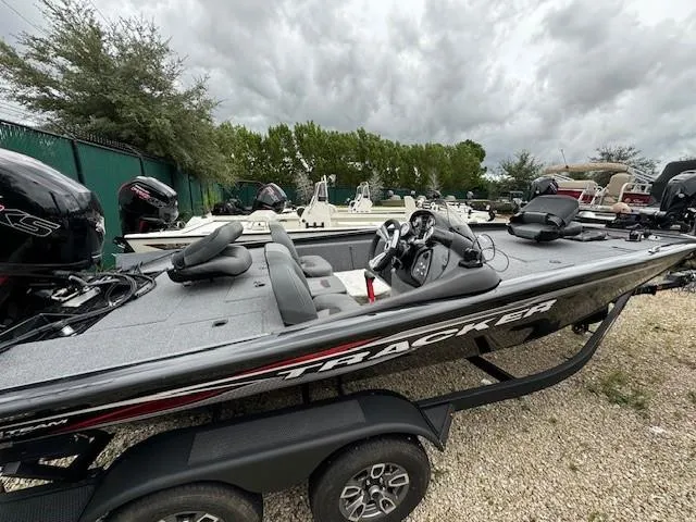 Slide: The Image of 2024 Tracker Pro Team 195 TXW Tournament Edition boat on trailer, parked outdoors. - 3