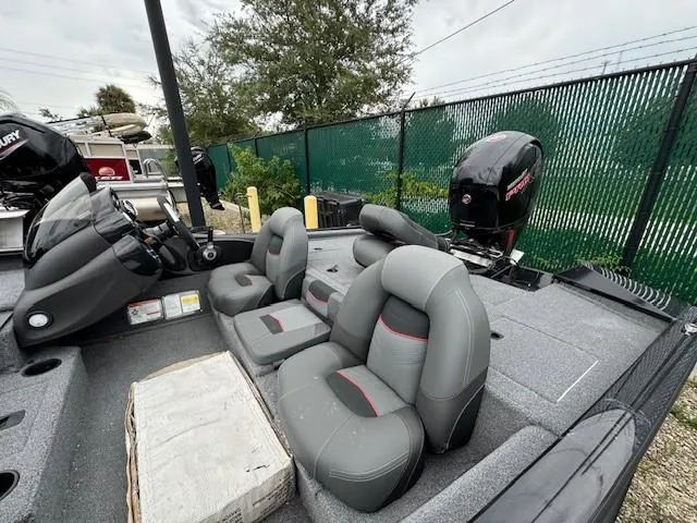 Slide: The Image of 2024 Tracker Pro Team 195 TXW Tournament Edition boat interior with seating and motor. - 5