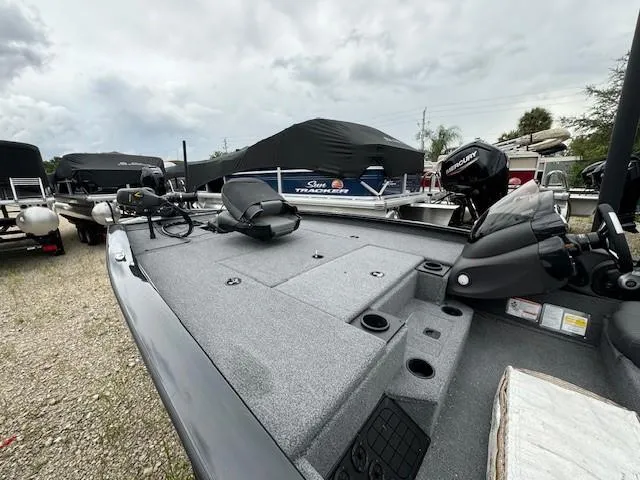 Slide: The Image of 2024 Tracker Pro Team 195 TXW Tournament Edition boat, gray deck, parked outdoors. - 6