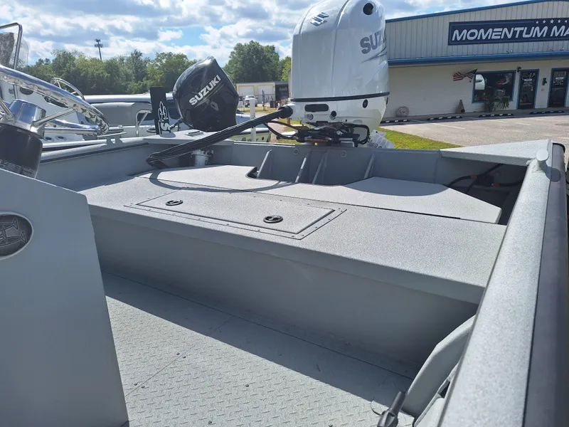 Slide: The Image of 2024 SeaArk 2472 CUB boat with Suzuki outboard motor at dealership. - 5