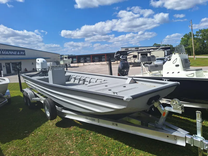 Slide: The Image of 2024 SeaArk 2472 CUB boat on trailer at dealership under blue sky. - 6