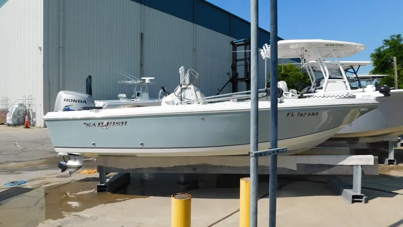 Slide: The Image of 2006 Sailfish 1900 boat on a dock with Honda outboard motor. - 1