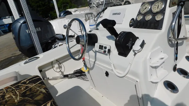 Slide: The Image of 2006 Sailfish 1900 boat cockpit with steering wheel, controls, and Yamaha engine. - 10