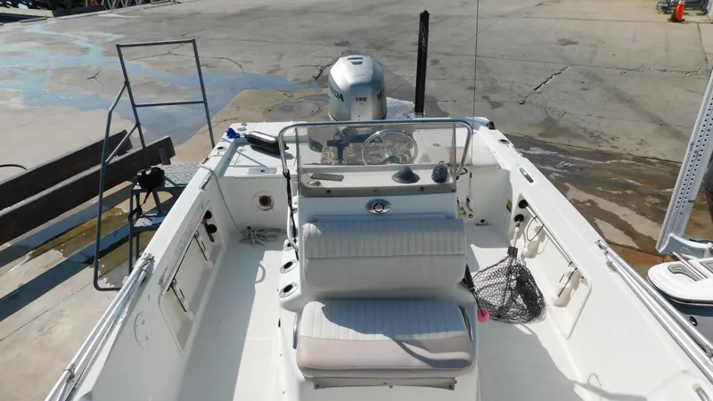 Slide: The Image of 2006 Sailfish 1900 boat interior with seating and outboard motor. - 11