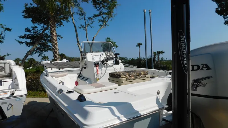 Slide: The Image of 2006 Sailfish 1900 boat with Honda outboard motor in a sunny marina. - 5