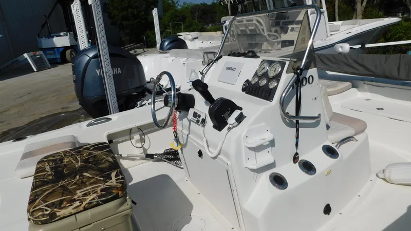 Slide: The Image of 2006 Sailfish 1900 boat interior with Yamaha engine and camo seat. - 8