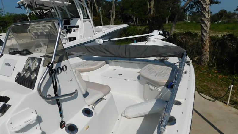 Slide: The Image of 2006 Sailfish 1900 boat with seating and control panel, docked outdoors. - 9