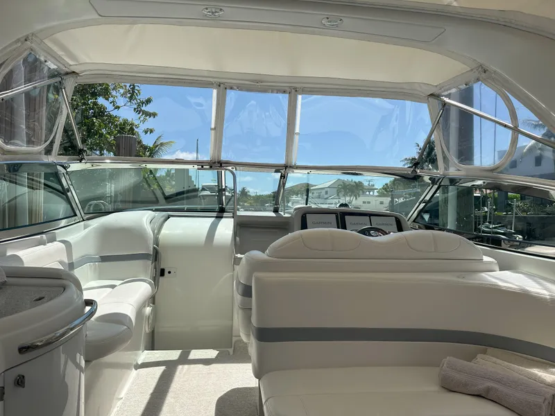 Slide: The Image of Interior of a 2004 Formula 330 SS boat with white seating and clear windows. - 10