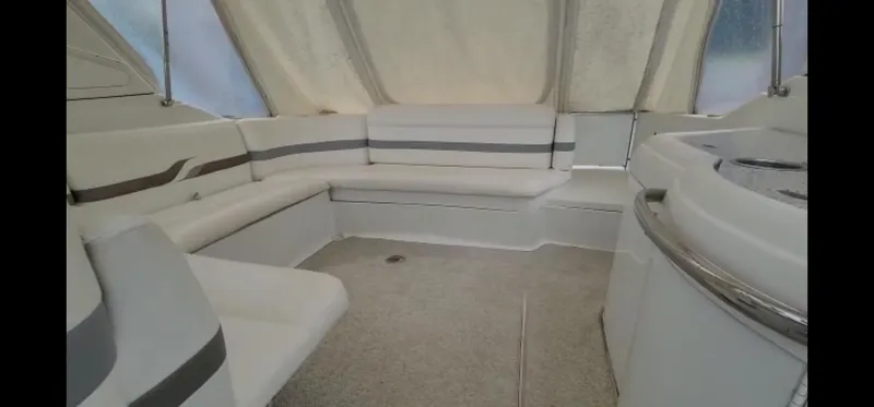 Slide: The Image of 2004 Formula 330 SS boat interior with white seating and carpeted floor. - 11